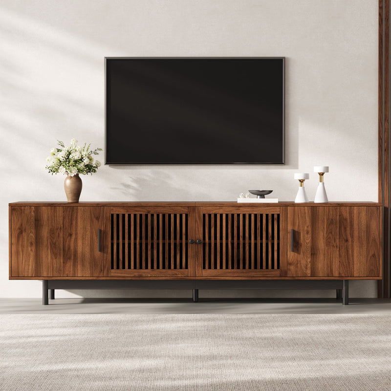 Walnut media console with slatted door panels and an open center TV shelf