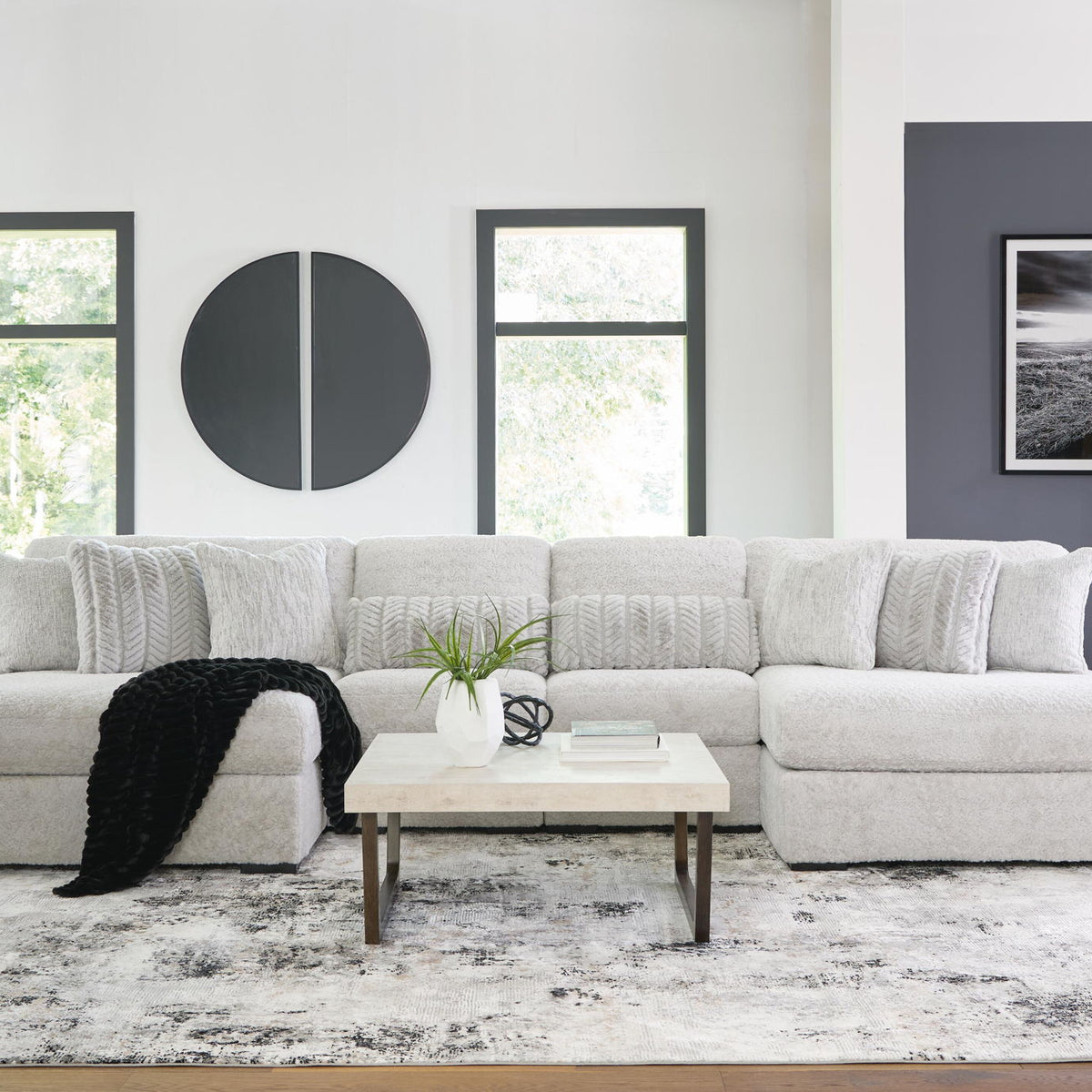 White plush sectional sofa with wide chaise, tufted cushions, and rounded armrests
