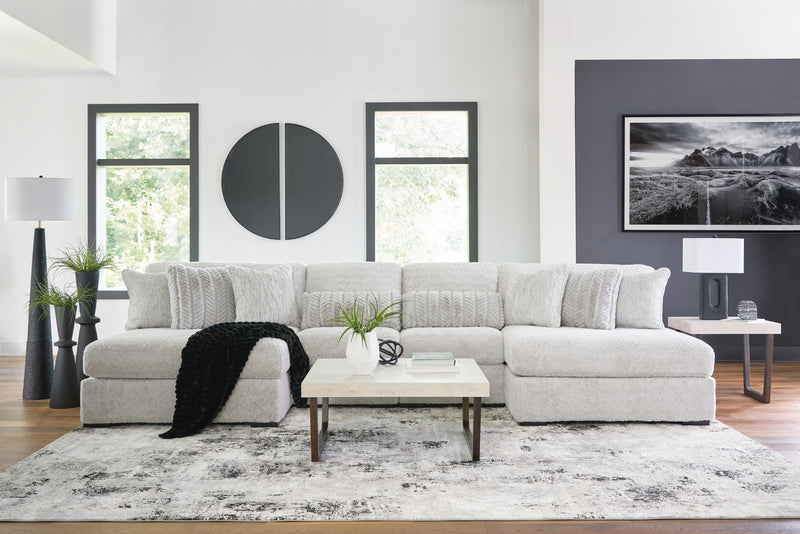 White plush sectional sofa with wide chaise, tufted cushions, and rounded armrests
