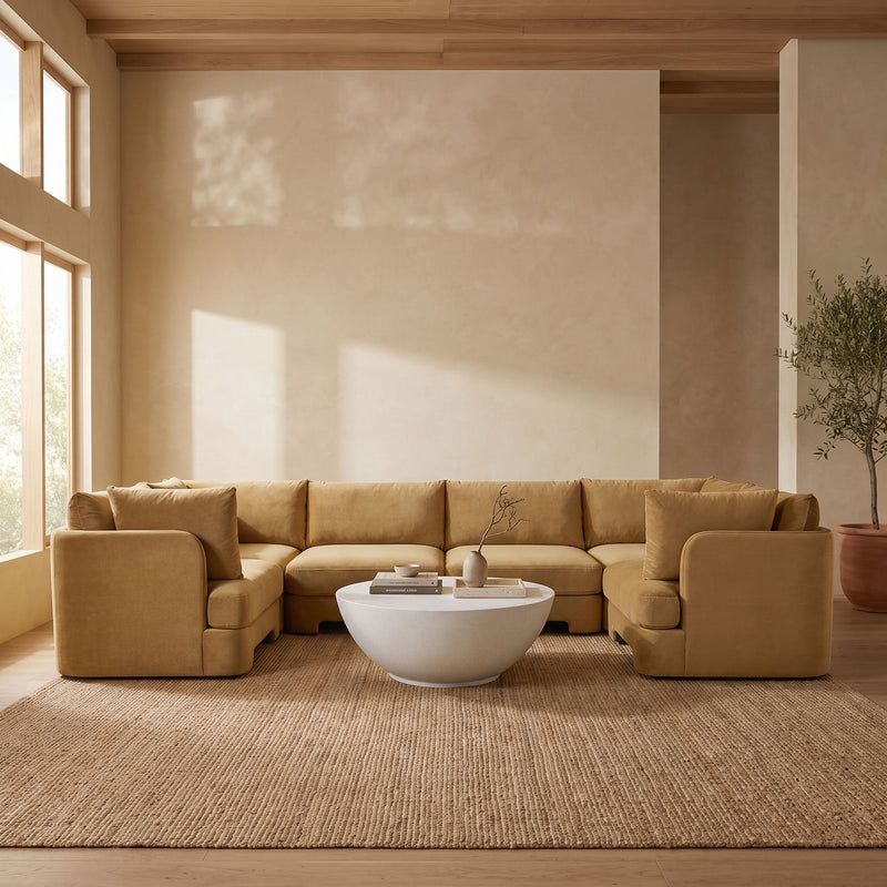 Light brown velvet U-shaped sectional sofa styled in a living room