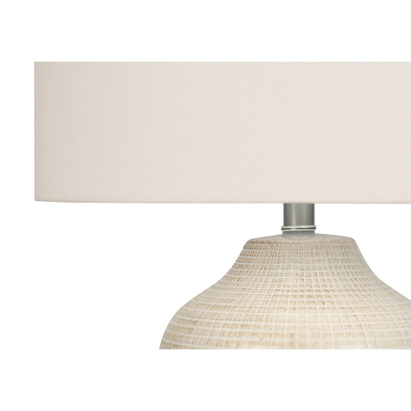 Textured ceramic table lamp base with metal stem and white fabric drum shade