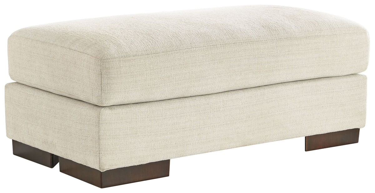 Light birch upholstered ottoman with rounded top and dark wooden legs