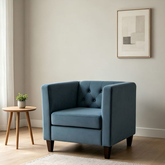 Blue tufted accent side chair with square arms, upholstered seat, and dark legs.