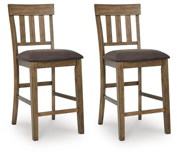 Pair of light brown upholstered barstools with dark seats and slatted backrests.