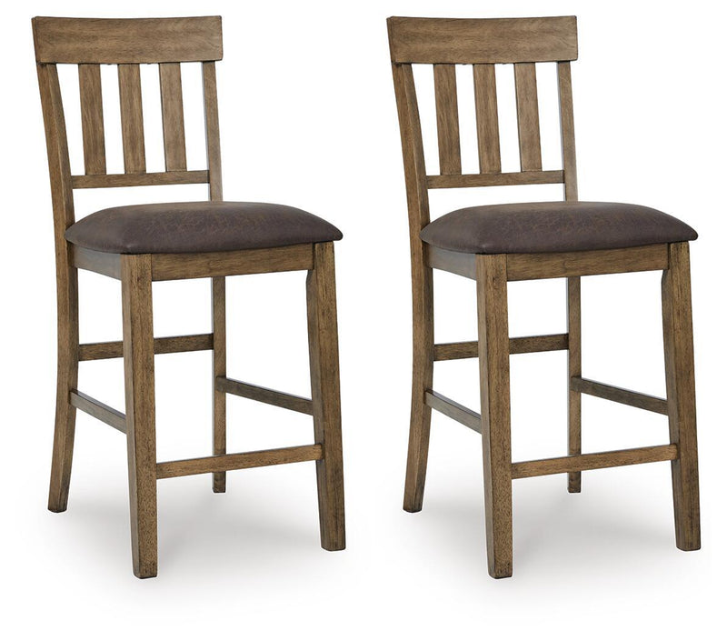 Pair of light brown upholstered barstools with dark seats and slatted backrests.