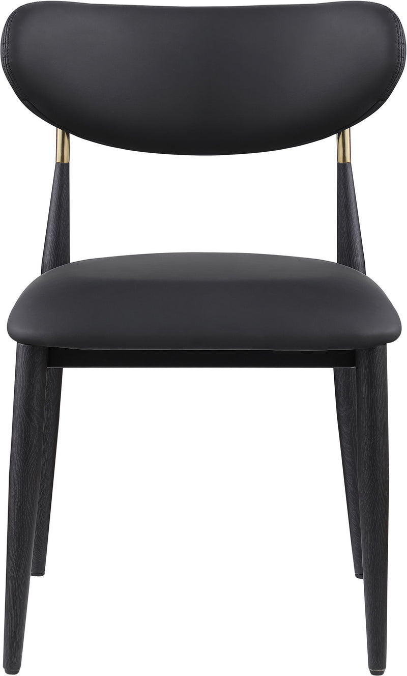 Black vegan leather dining side chair with rounded back and seat, black legs with gold tips