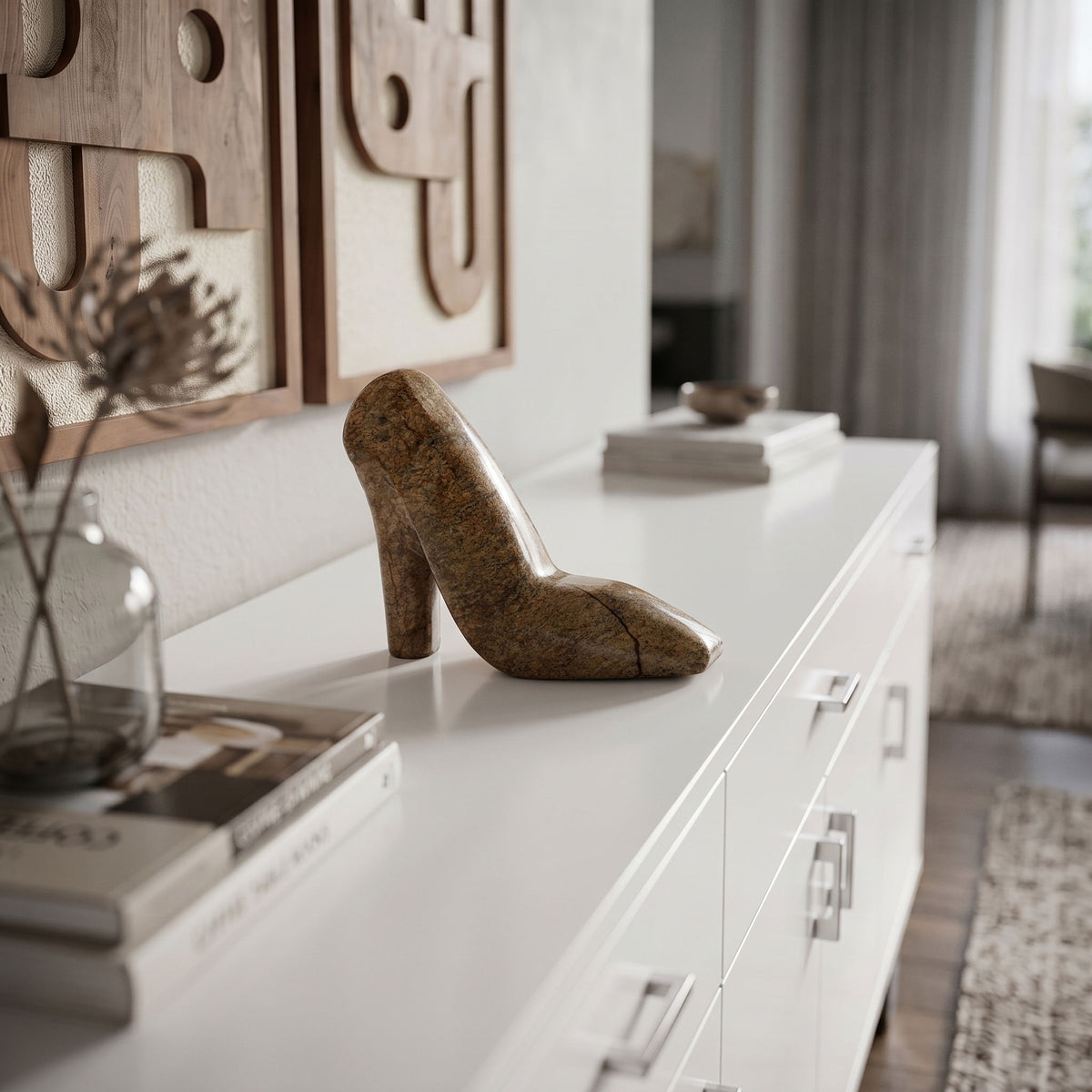 Brown marble high-heel shoe sculpture displayed on a white console