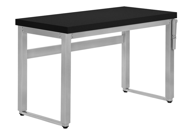Standing adjustable computer desk with black top and silver metal legs