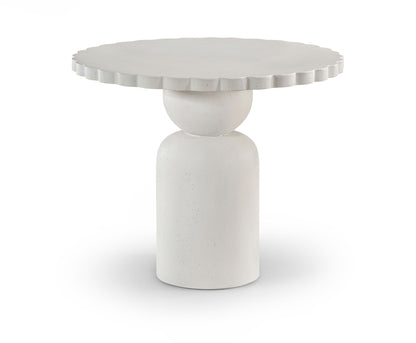 Round indoor/outdoor table with fluted apron and tapered pedestal base in light white.