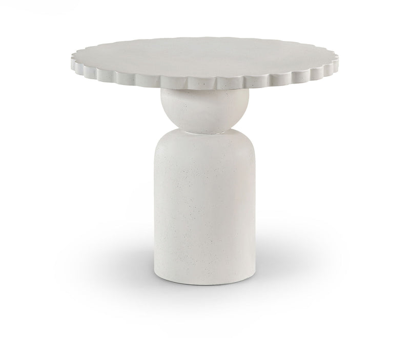 Round indoor/outdoor table with fluted apron and tapered pedestal base in light white.