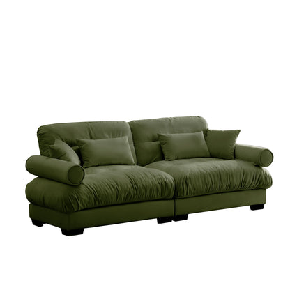 Dark green modern sofa with round bolstered armrests and matching back pillows