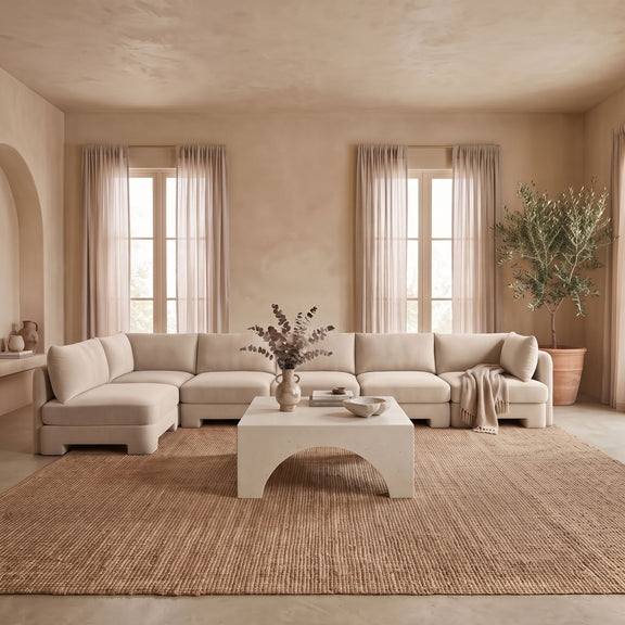 Light beige L-shaped armless sectional sofa with velvet-style upholstery and padded back cushions