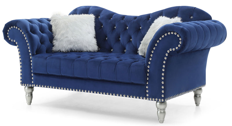 Blue velvet round arm loveseat with tufted back, nailhead trim, and white faux fur pillow.