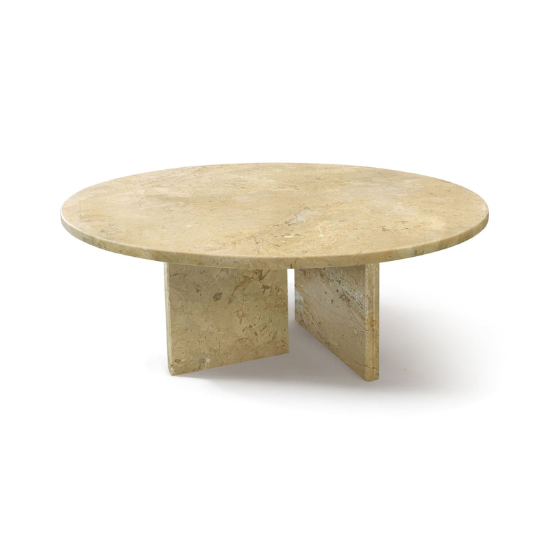 Round beige stone coffee table with distinctive veining and angled pedestal base.
