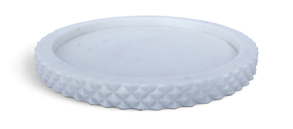 White marble tray with textured rim and round shallow center.