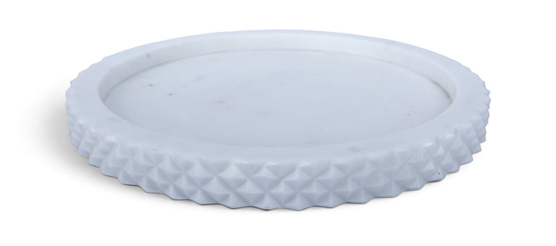 White marble tray with textured rim and round shallow center.
