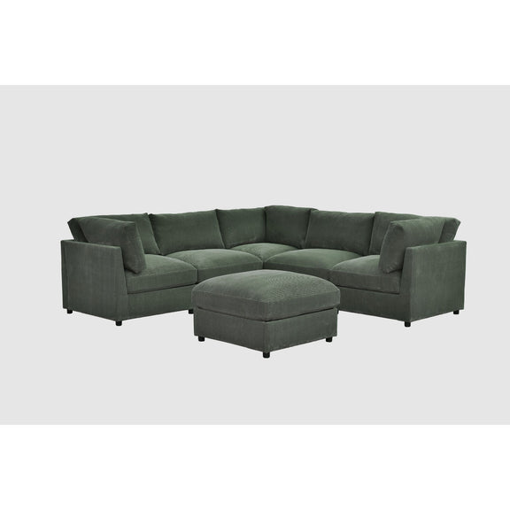 Dark green sectional sofa with ottoman bench seat and tufted back cushions