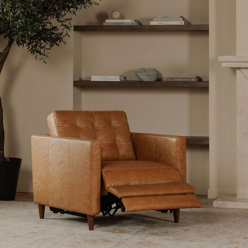 Tan leather recliner chair with extended footrest and visible power reclining mechanism