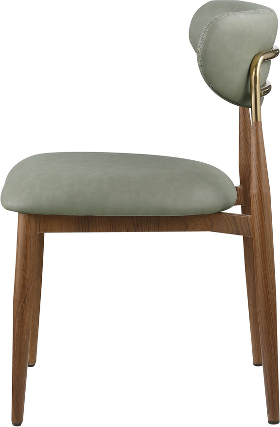 Green vegan leather dining side chair, close-up view with walnut legs