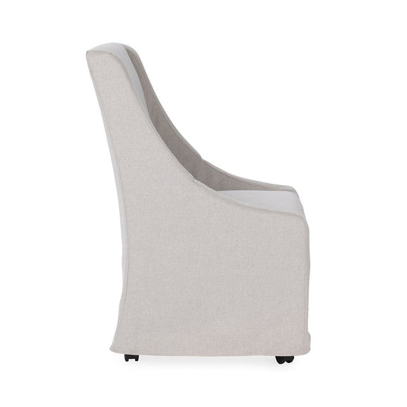 Upholstered rolling dining chair, light gray fabric with curved arms and casters