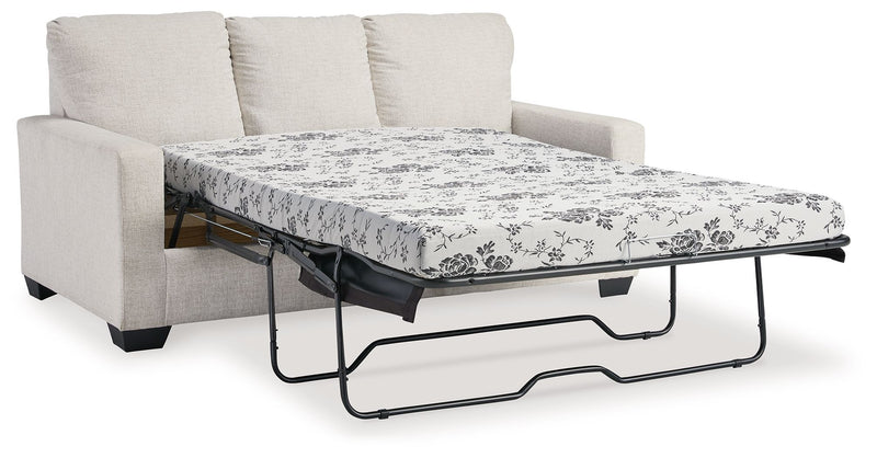 Light beige sofa with pull-out bed frame and white floral patterned mattress cover