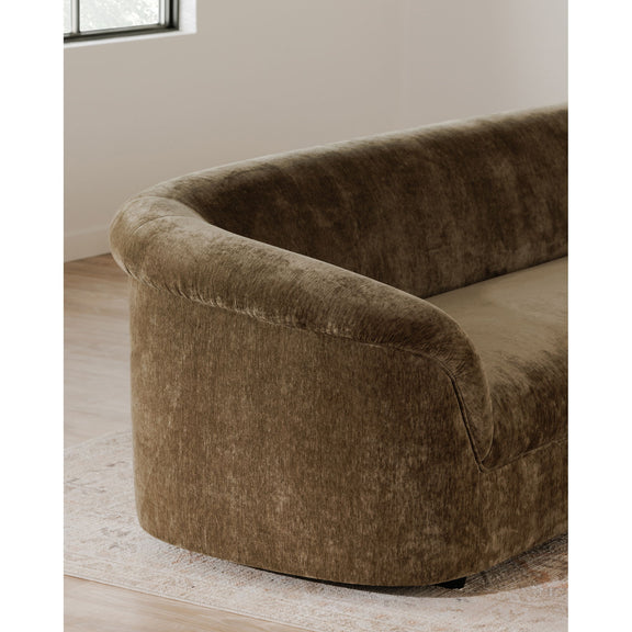 Dark green upholstered sofa arm and side panel, rounded silhouette and curved base