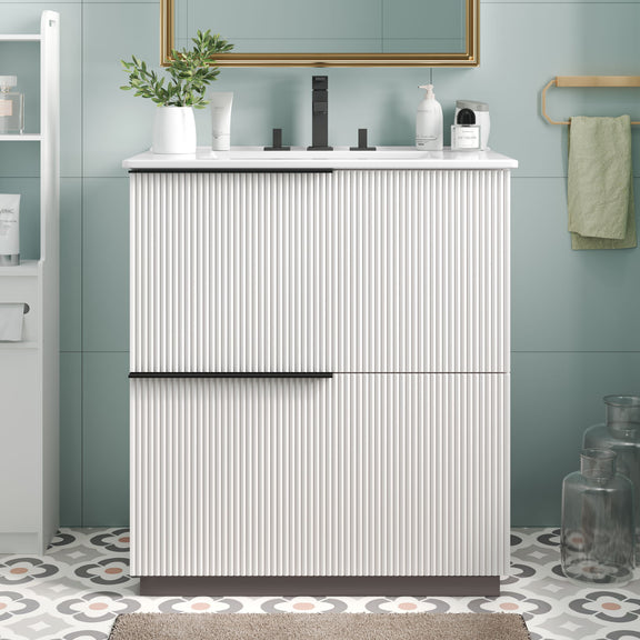 White fluted bathroom vanity with white ceramic sink and center handle bar