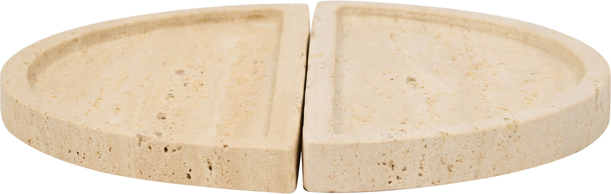 Beige travertine tray close-up with two semicircular halves separated by a seam.