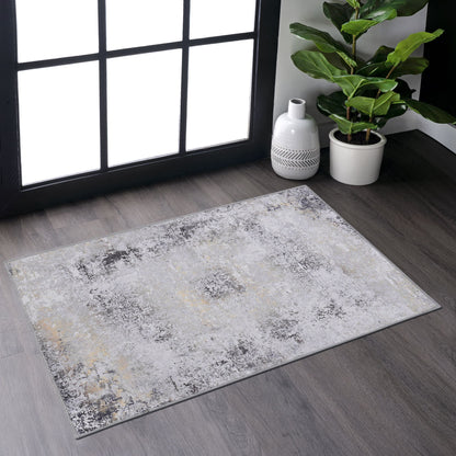Machine-washable area rug with light gray distressed speckled abstract pattern