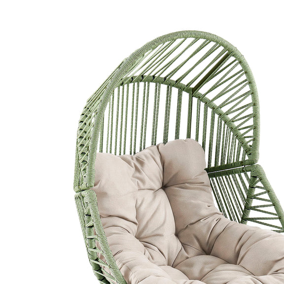 Green rattan lounge chair with beige seat cushion and tufted back