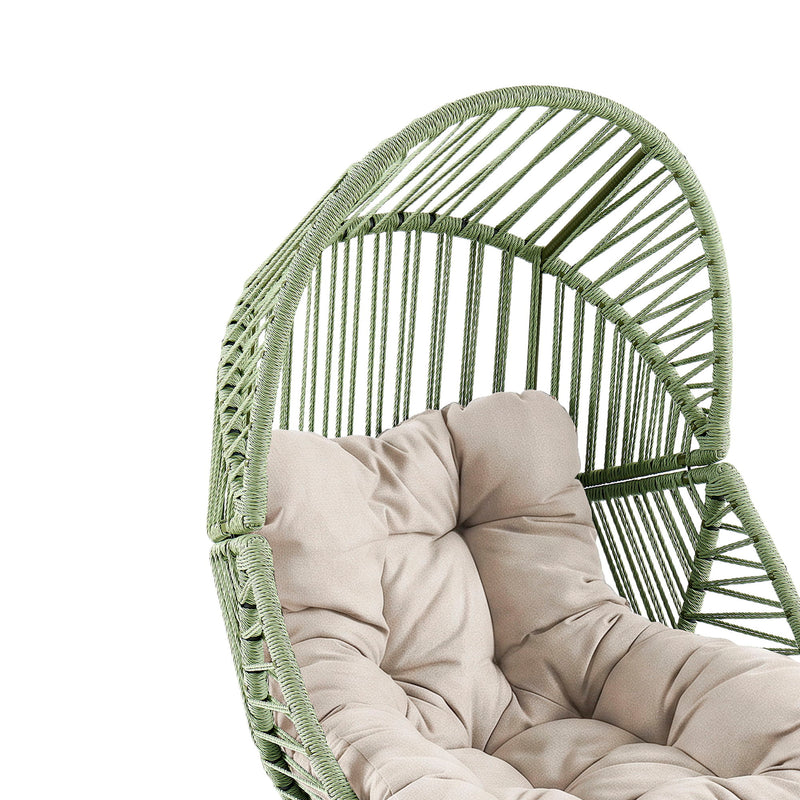 Green rattan lounge chair with beige seat cushion and tufted back