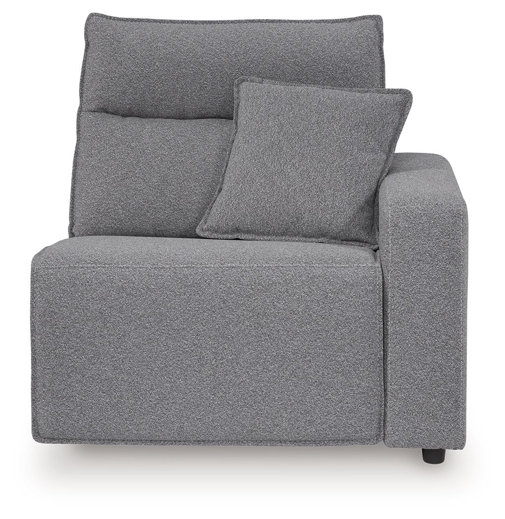 Salt-and-pepper gray upholstered recliner with padded back, side arms, and throw pillow