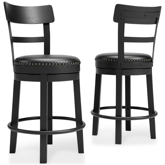 Pair of black swivel bar stools with studded round upholstered seats and curved footrest ring