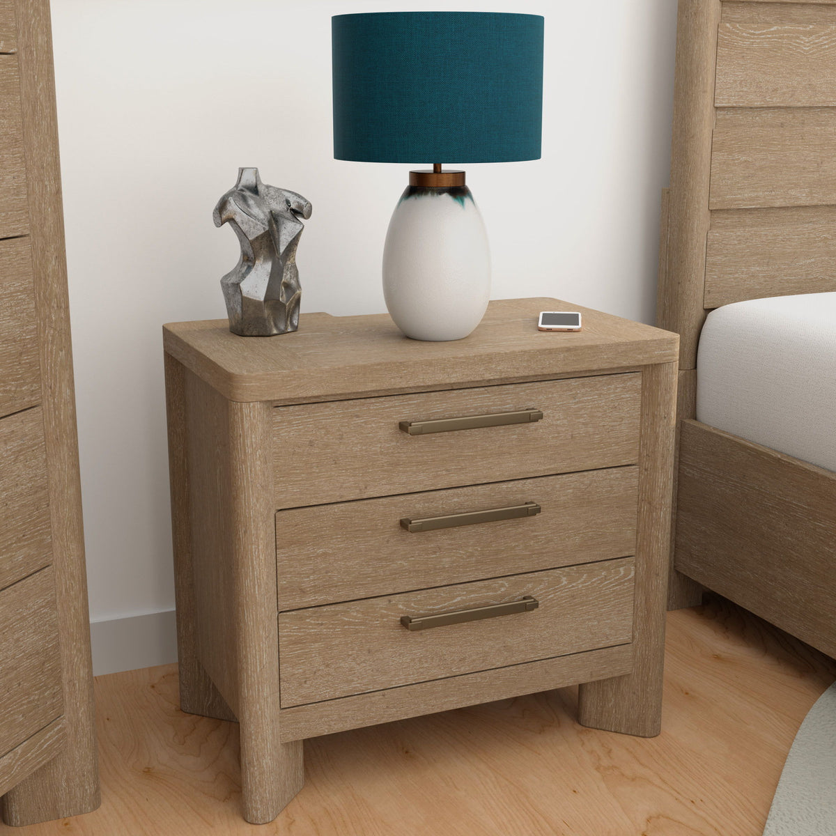 Tan wood nightstand with three drawers and metal bar handles, compact bedside size