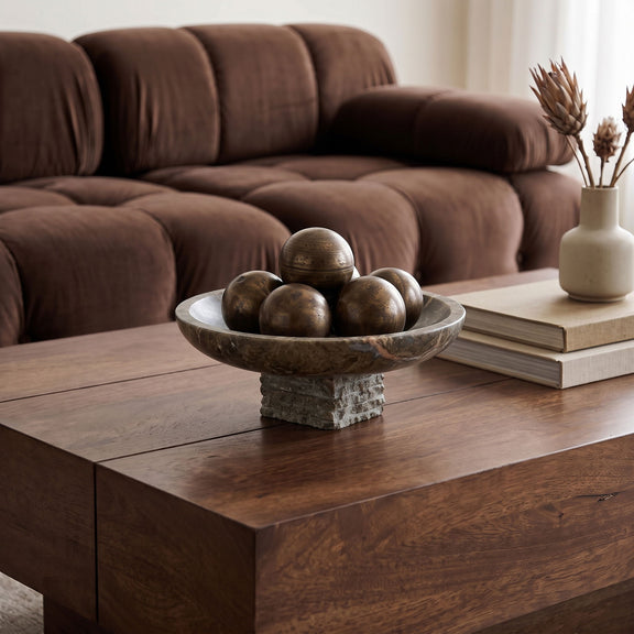 Marble bowl centerpiece on table, filled with decorative spheres
