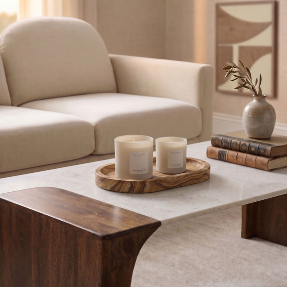 Sandstone tray holding two white candles
