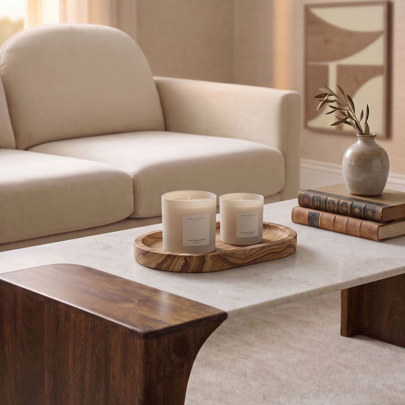 Sandstone tray holding two white candles