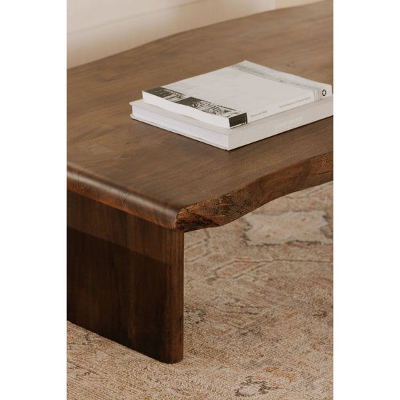 Brown wooden coffee table corner with visible grain and square leg