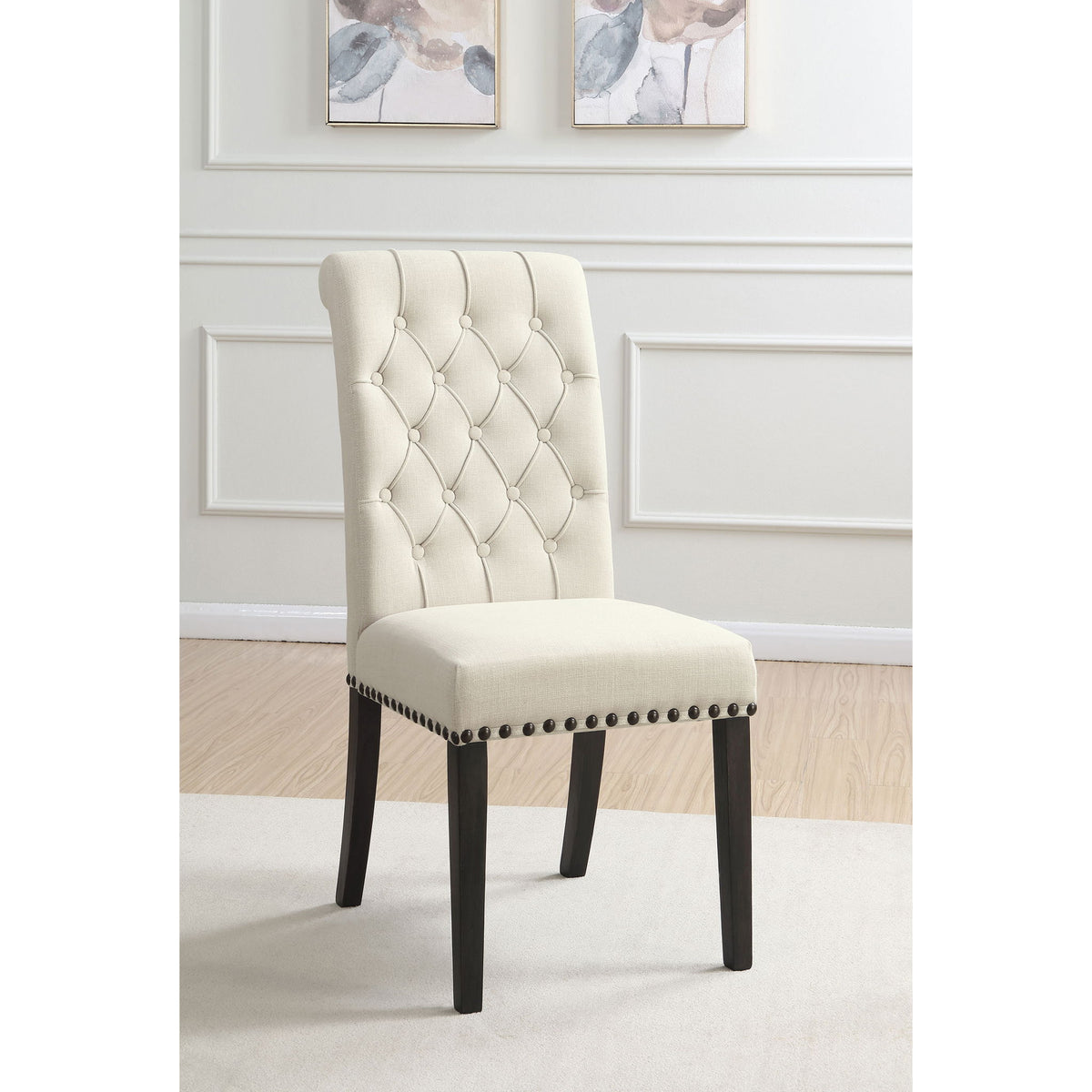 Beige tufted rolled backrest side chair with nailhead trim and dark wooden legs