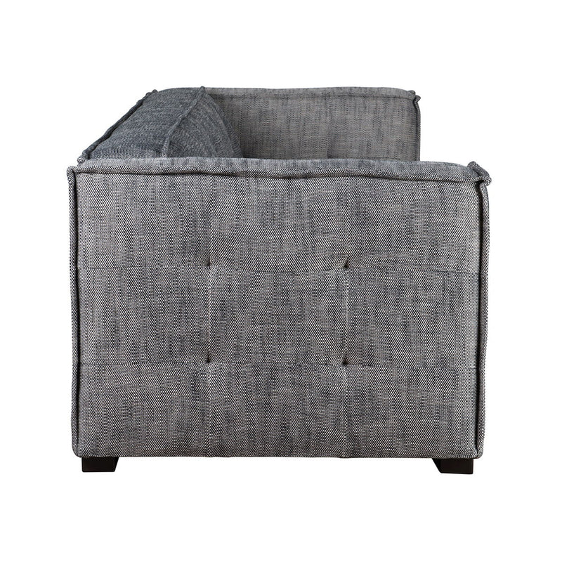 Gray fabric sofa with boxy arms, tufted back cushions, and dark wooden legs.