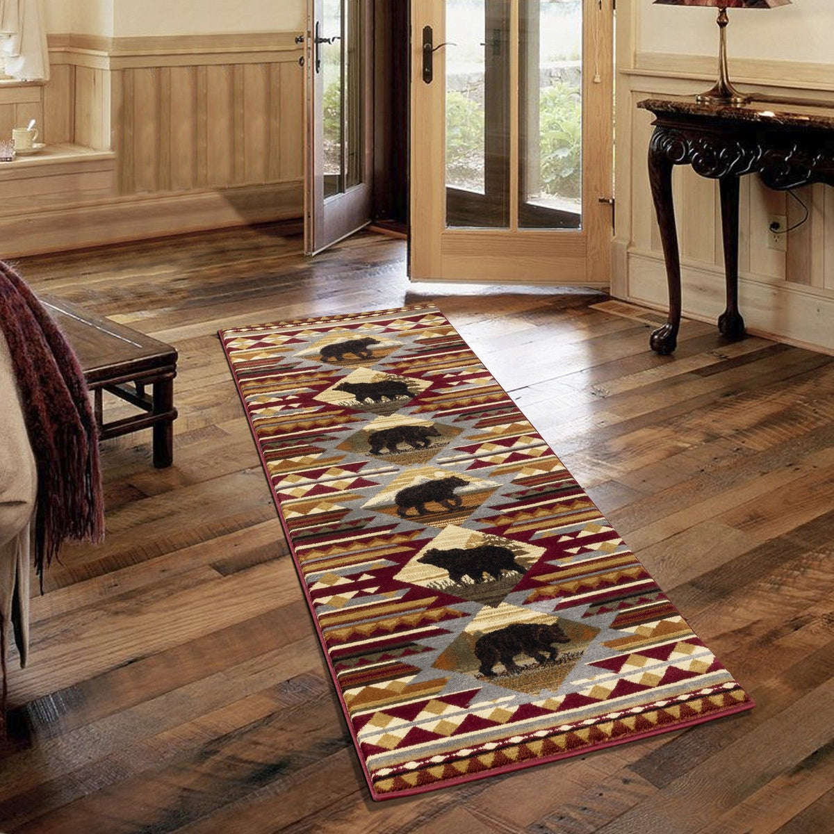 Red lodge area rug runner with repeating bear graphics and diamond motif border