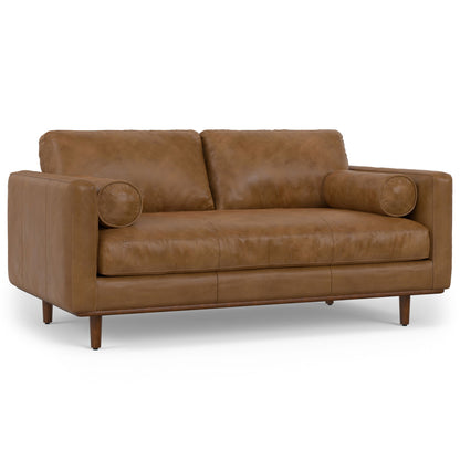 Brown upholstered sofa with two seat cushions and round accent pillows at the arms.