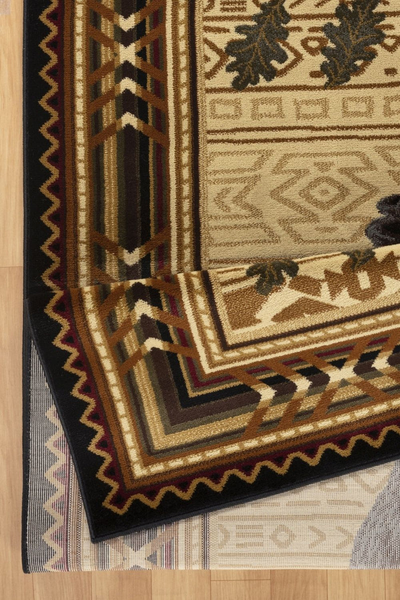 Close-up of rectangular rug corner: dark border, cream field with black bear design
