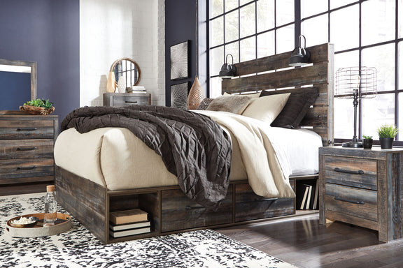 Drystan panel bed with dark wood frame, slatted headboard, and neutral throw pillows