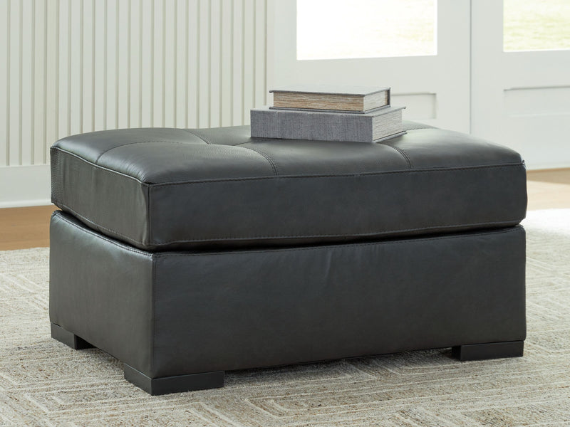 Oversized accent ottoman in dark gray with cushioned top and block feet