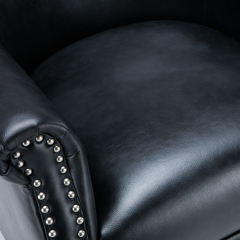 Dark leather-look upholstery and studded armrest detail on club chair