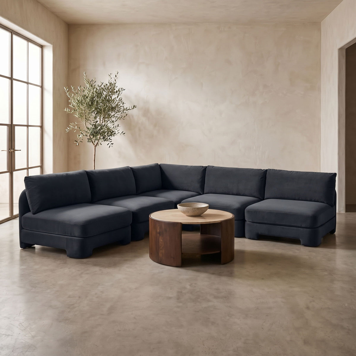 Dark blue armless velvet sectional sofa with deep seats and padded back cushions.