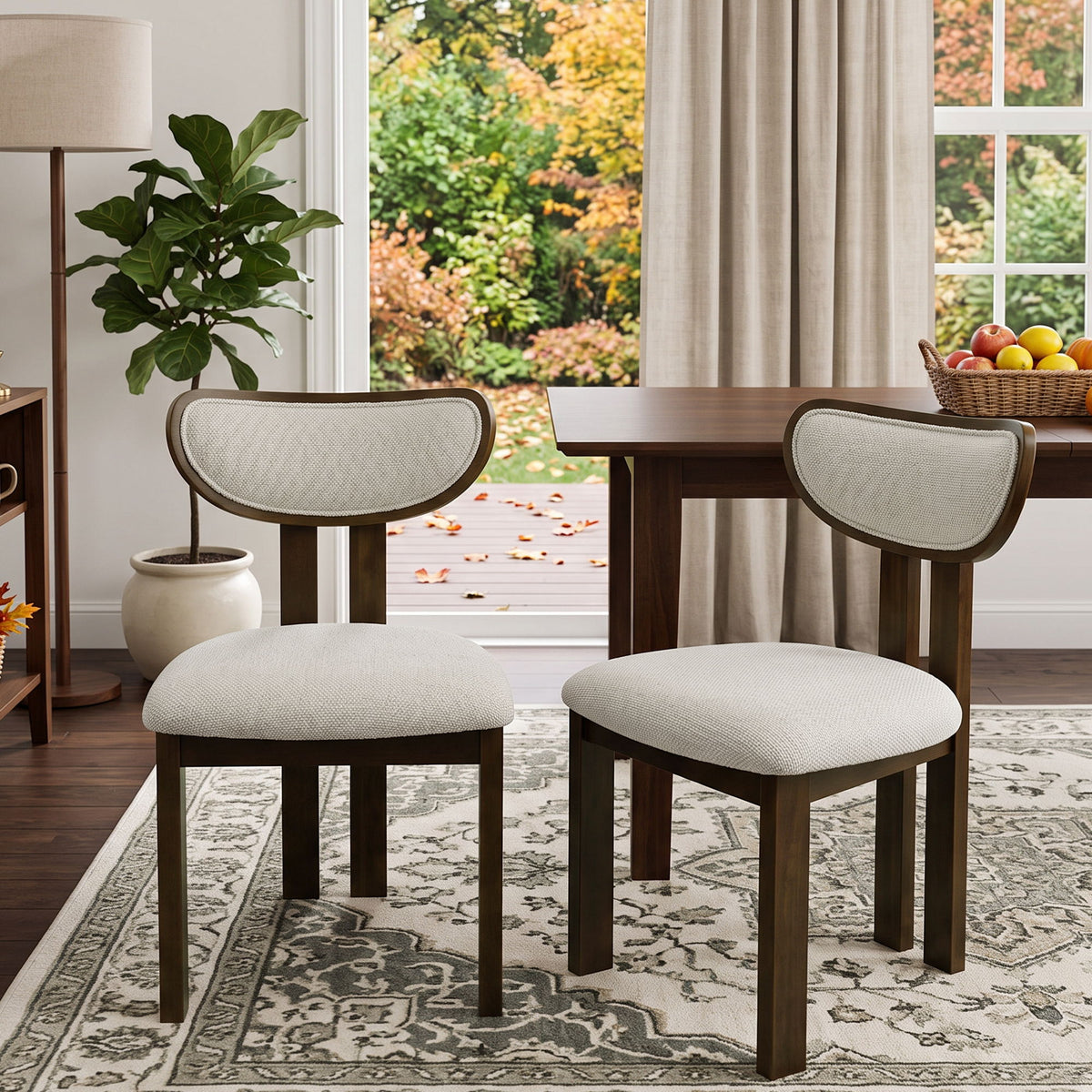 Beige upholstered dining chairs with curved backs and dark wood frames