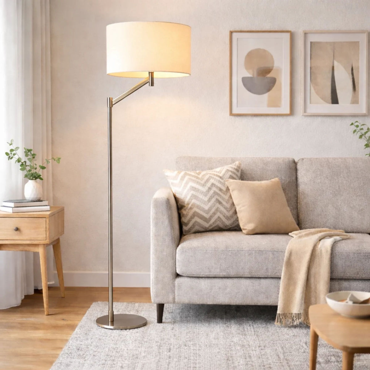 Floor lamp with brushed nickel stand, white drum linen shade, and round base