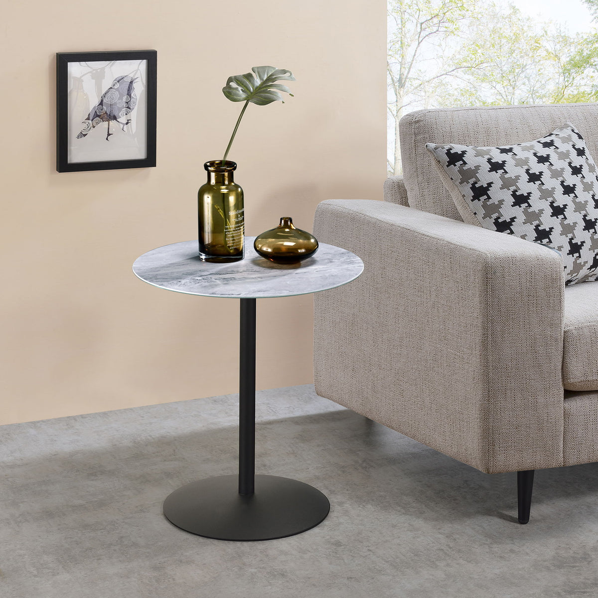 Round end table with black pedestal and white-gray marble-textured top